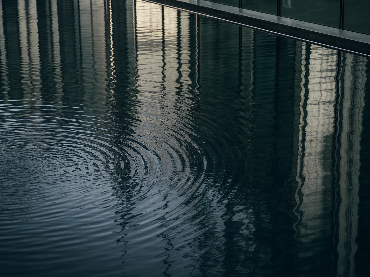 Ripples reflecting a glass facade